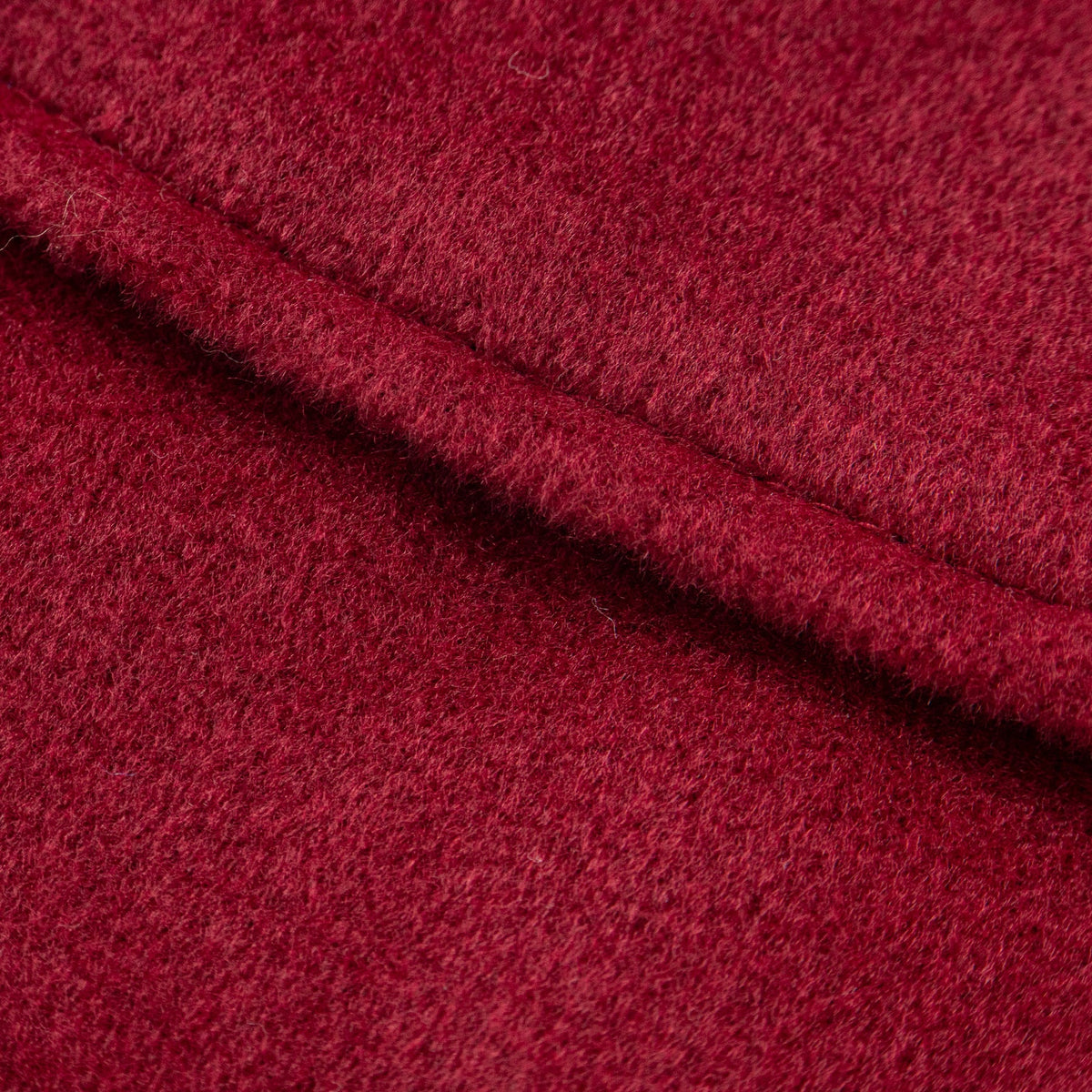 A scarlet woollen coat, two front pockets and a zipper for front fastening.