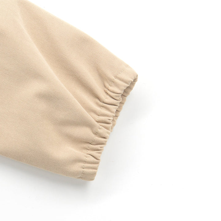 Hooded Light khaki jacket, two front pockets, golden snap buttons at the front. Elasticated cuffs.