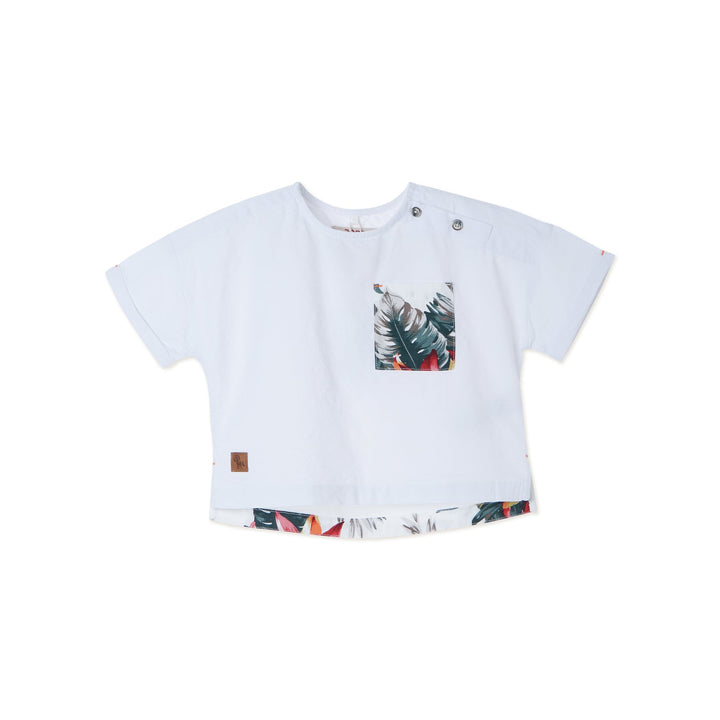 White tropical themed shirt, buttoned shoulder strap, front pocket. Back hem slightly longer than the front. Logo tag attached. 