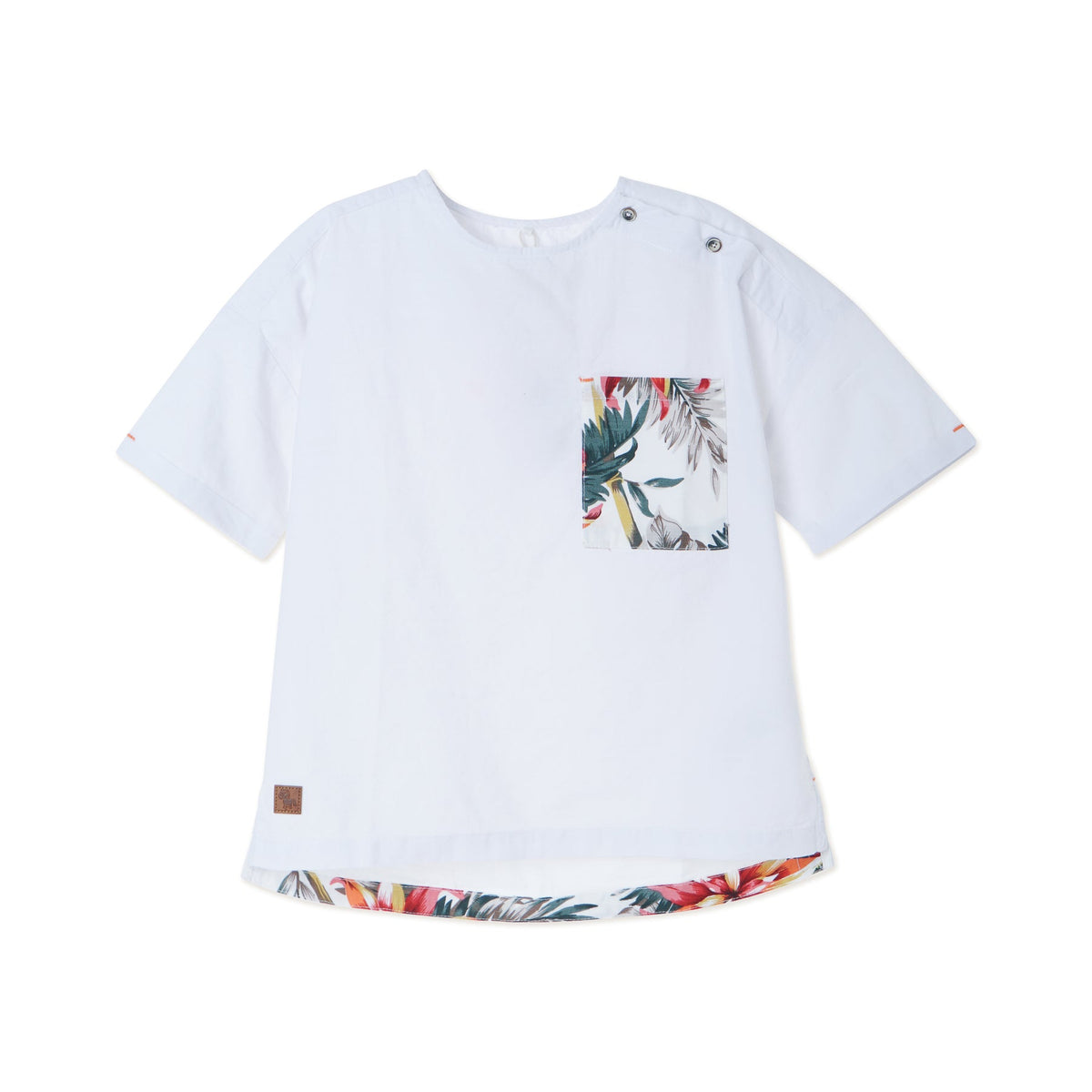 White tropical themed shirt, buttoned shoulder strap, front pocket. Back hem slightly longer than the front. Logo tag attached. 