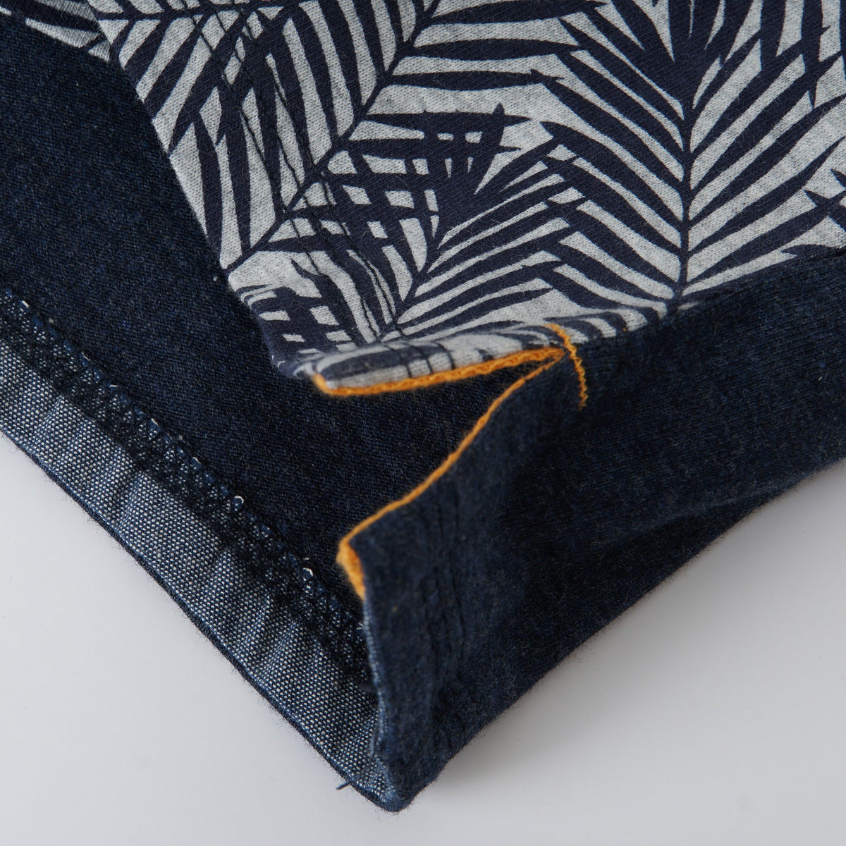 Navy and white top, faded centre button fastening, yellow pocket.