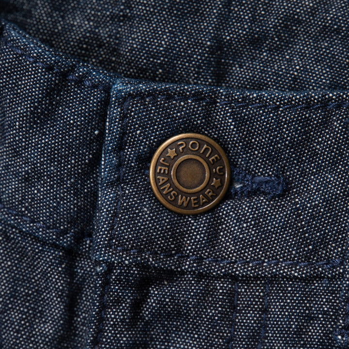 Elasticated dark blue jeans, skeletal dinosaur embroidered one leg front. Embossed caption on other leg front, metallic button fastening.