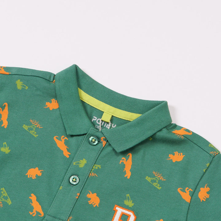 Green Cotton Polo, Orange T-Rex, Triceratops and Volcano Prints. Rib-Knit Collar, Emroidered Poney Logo, Front buttoned and Longer Hem.