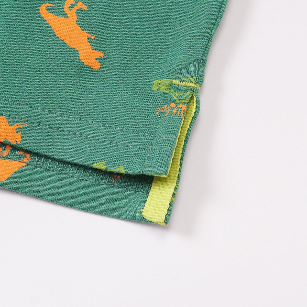 Green Cotton Polo, Orange T-Rex, Triceratops and Volcano Prints. Rib-Knit Collar, Emroidered Poney Logo, Front buttoned and Longer Hem.
