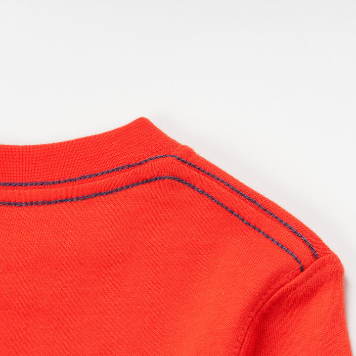 Red Dinosaur printed Top, long sleeves, buttoned shoulder strap. 