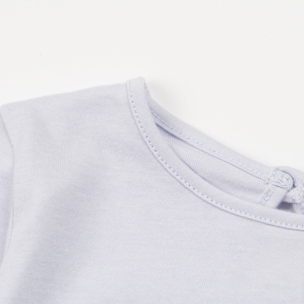 Light Blue ,Long Sleeve t-shirt with a big snoozing heart and poney print, buttoned at the back.