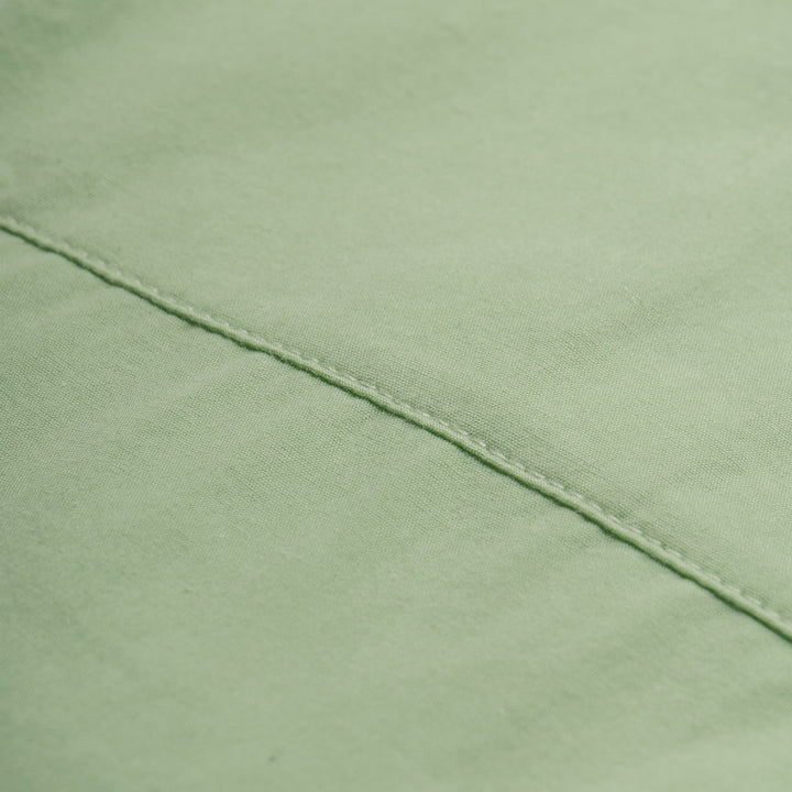 Light green, short sleeve top, button strapped shoulder and a cute logo tag attached. 