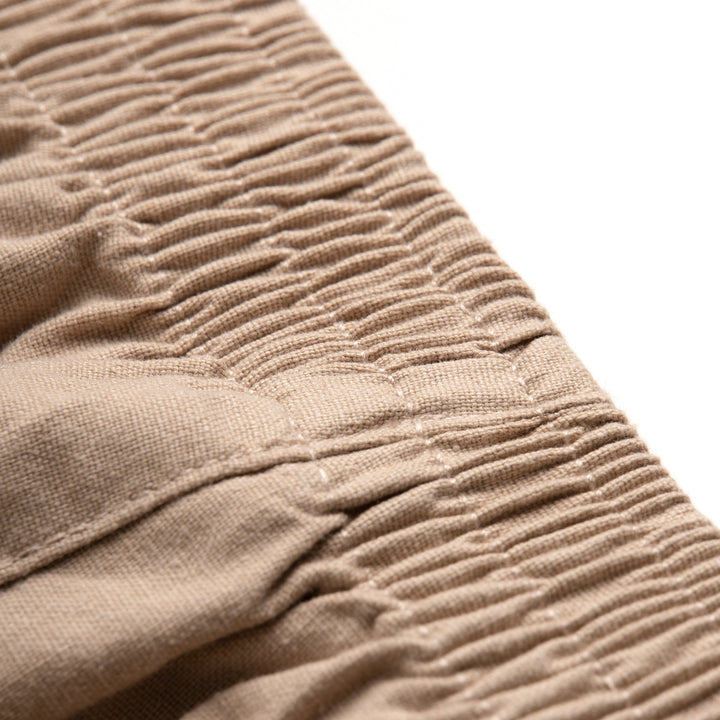 Uniquely styled, side fastening khaki, elasticated, side and back pockets included. Logo tag attached at the front.