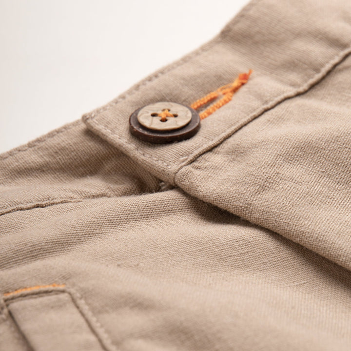 Uniquely styled, side fastening khaki, elasticated, side and back pockets included. Logo tag attached at the front.