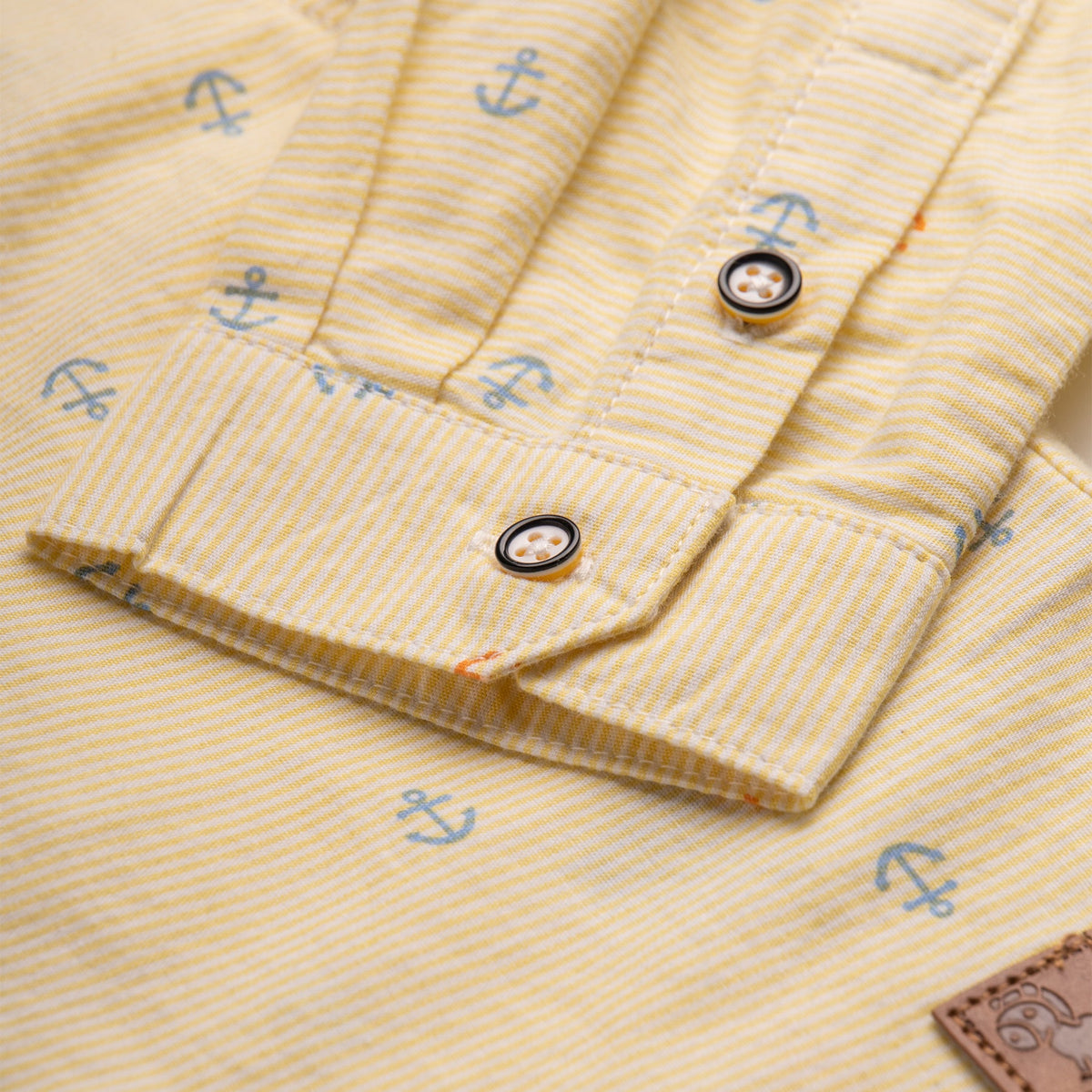 Yellow, full sleeve, collared, sailor shirt, with front buttons. Buttons included to sleeve to be rolled up and on cuffs. Poney tag stitched on the side. 