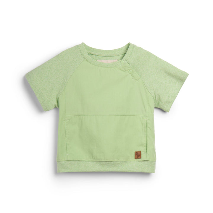 Light green, short sleeve top, button strapped shoulder and a cute logo tag attached. 