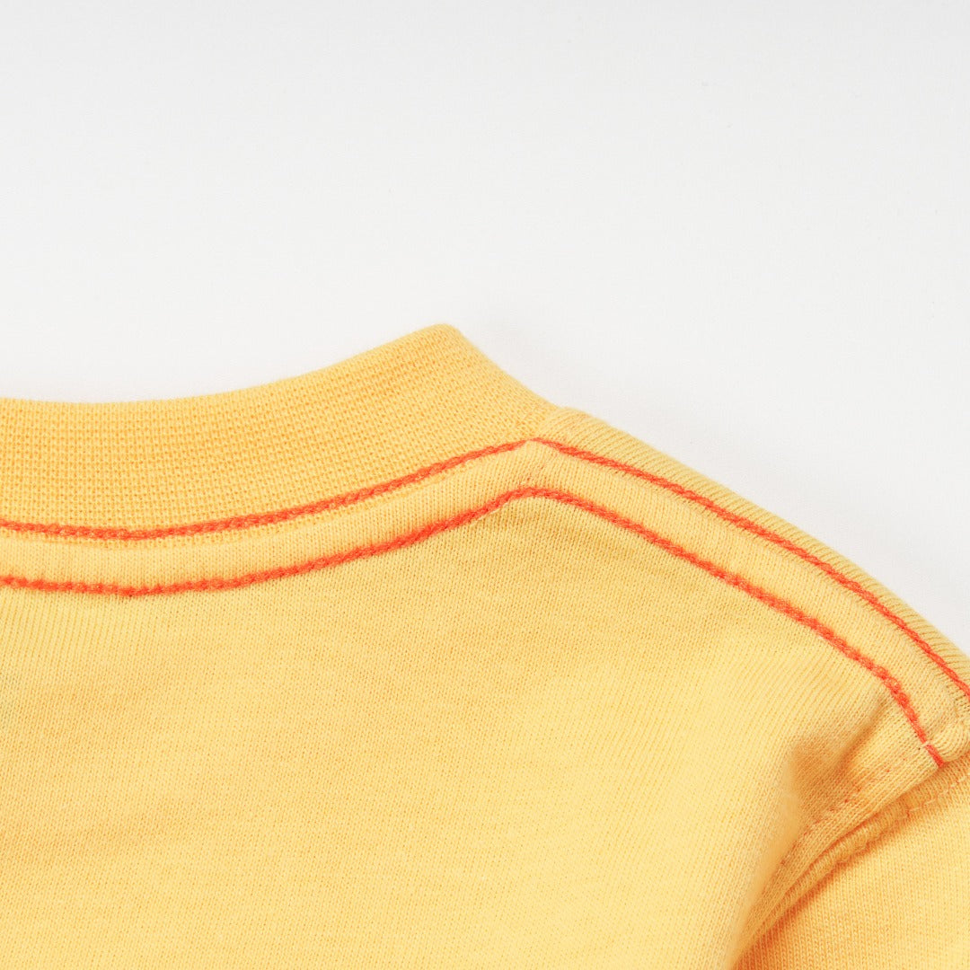 'Super Cool Monster' printed, yellow top, long sleeves, shoulder buttons. 