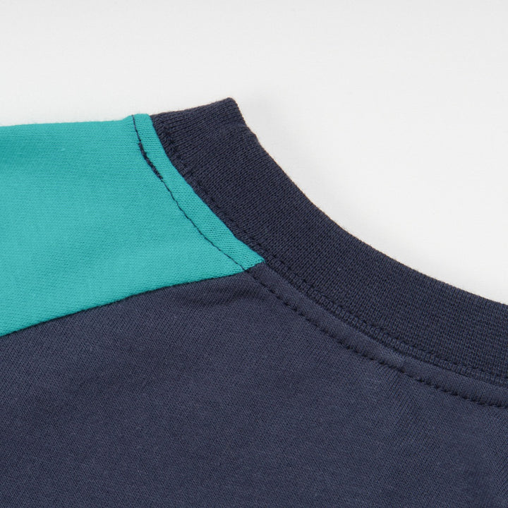 green and navy top, tetris design with shoulder fastening. 