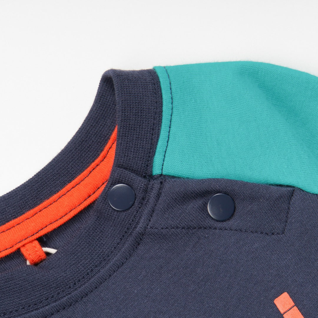 green and navy top, tetris design with shoulder fastening. 