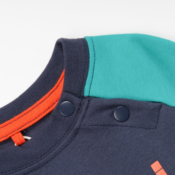 green and navy top, tetris design with shoulder fastening. 