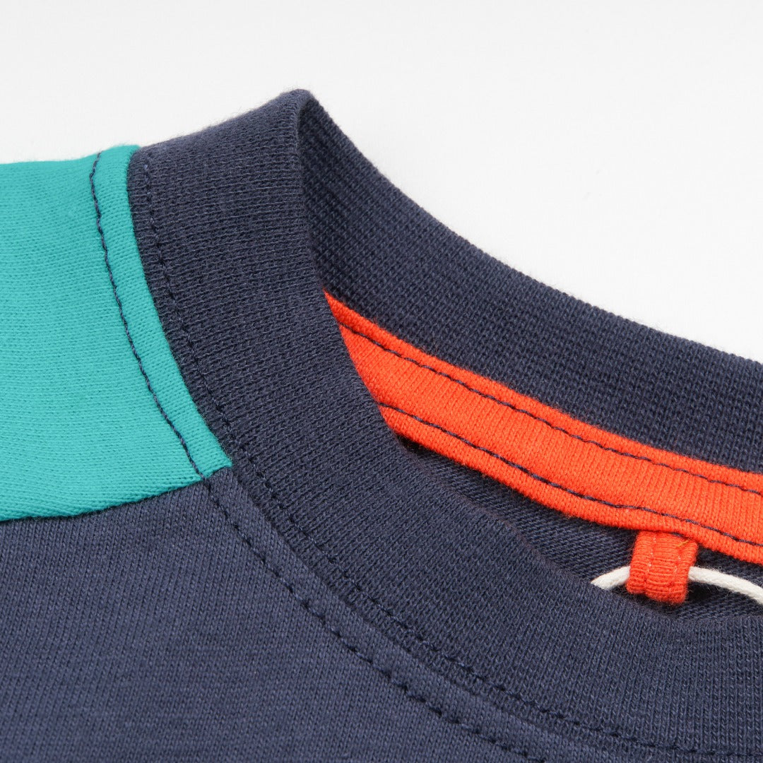 green and navy top, tetris design with shoulder fastening. 