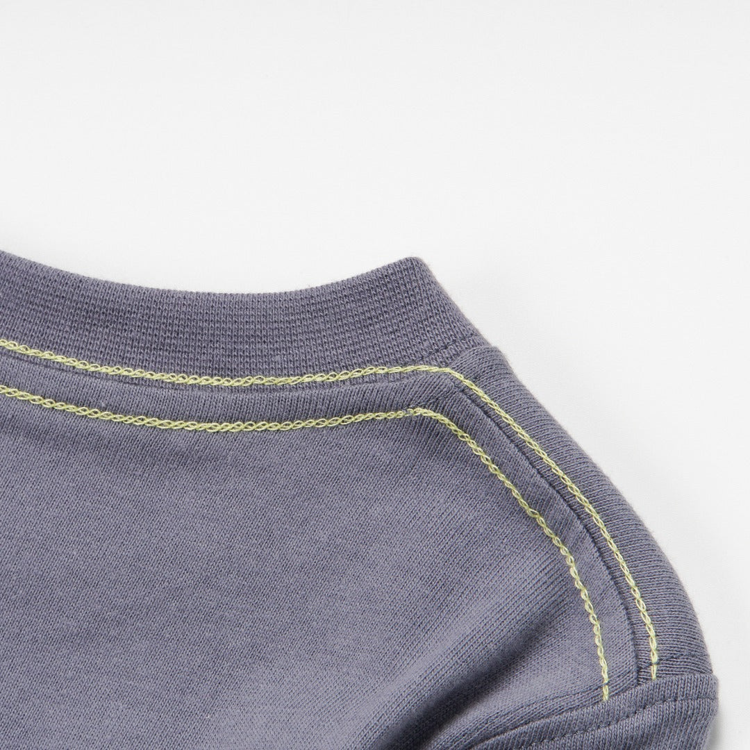 Dark grey top, blue fish skeleton and yellow poney bones. Doubled strapped shoulder fastenings, long sleeves. 