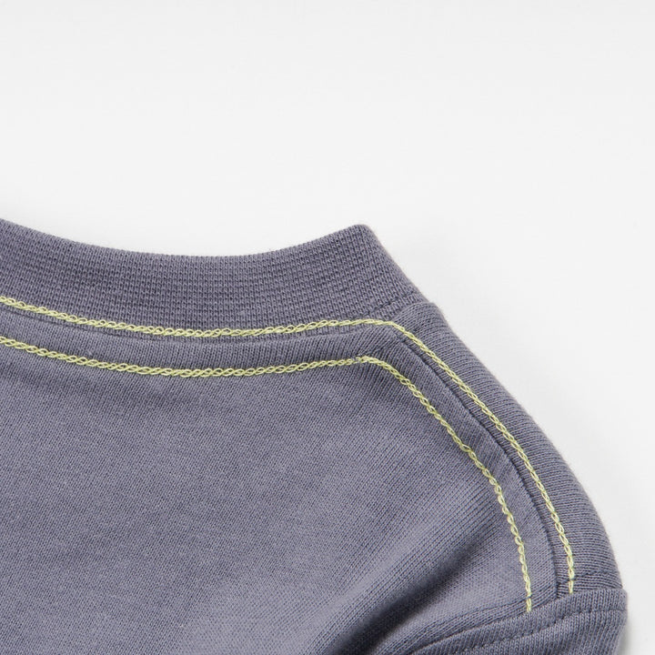 Dark grey top, blue fish skeleton and yellow poney bones. Doubled strapped shoulder fastenings, long sleeves. 